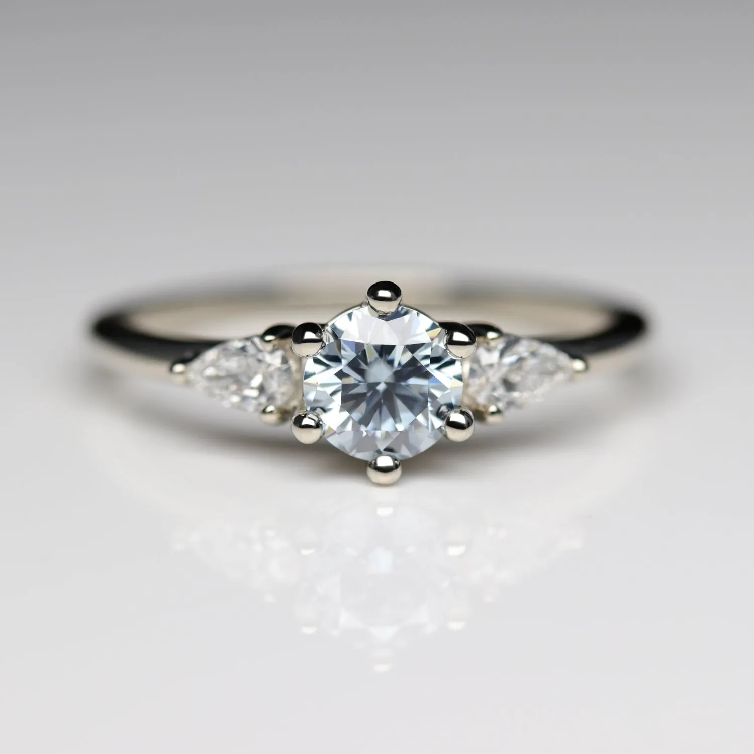 Prong-set Three Stone Ring with Light Blue Moissanite