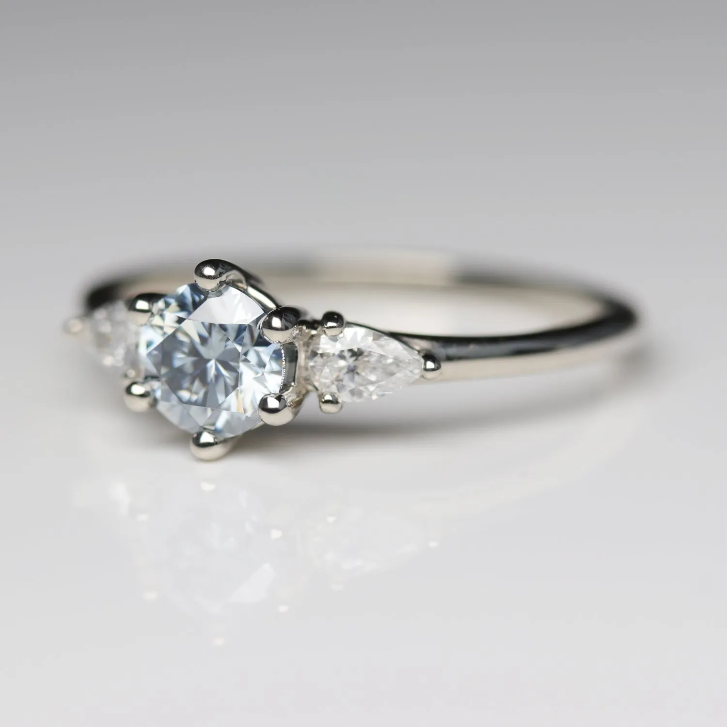 Prong-set Three Stone Ring with Light Blue Moissanite