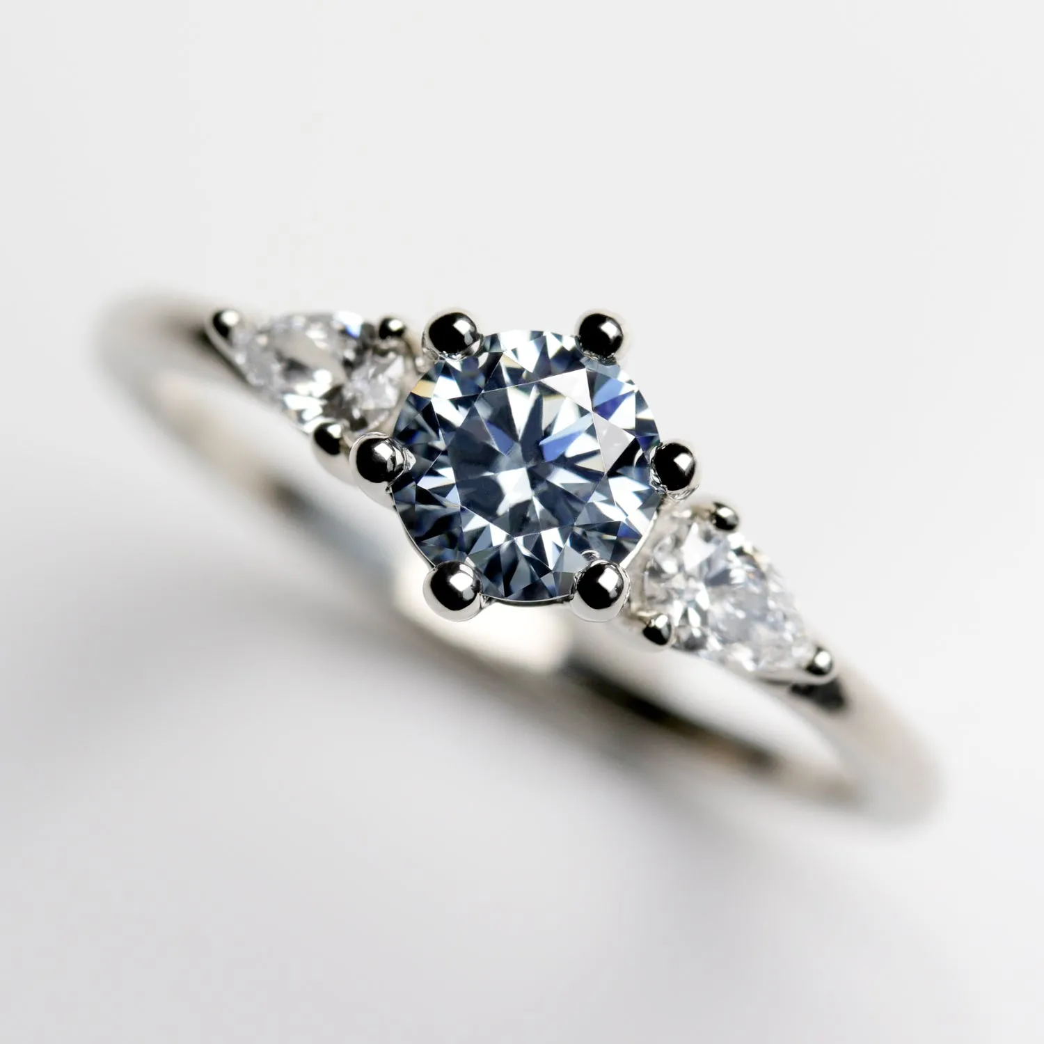 Prong-set Three Stone Ring with Light Blue Moissanite